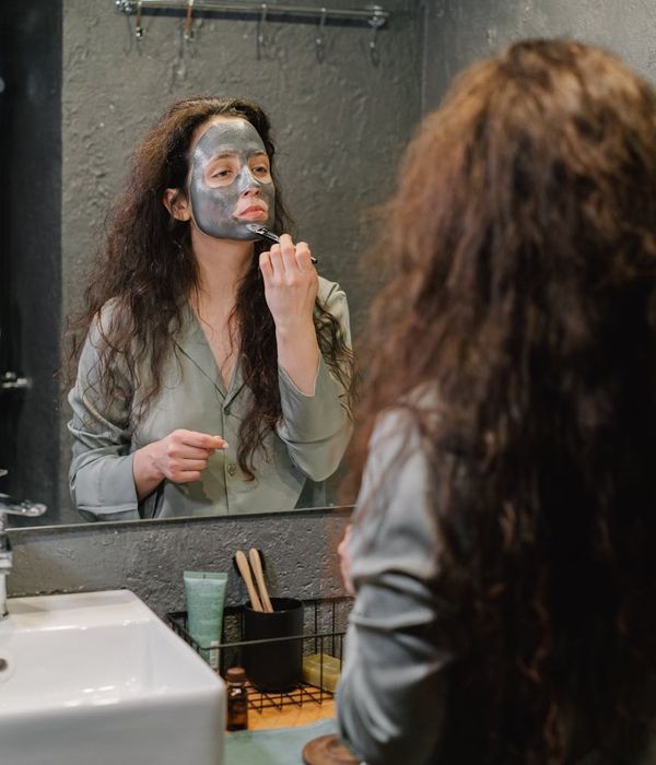 Person meditating peacefully with a purple and cream color theme.
